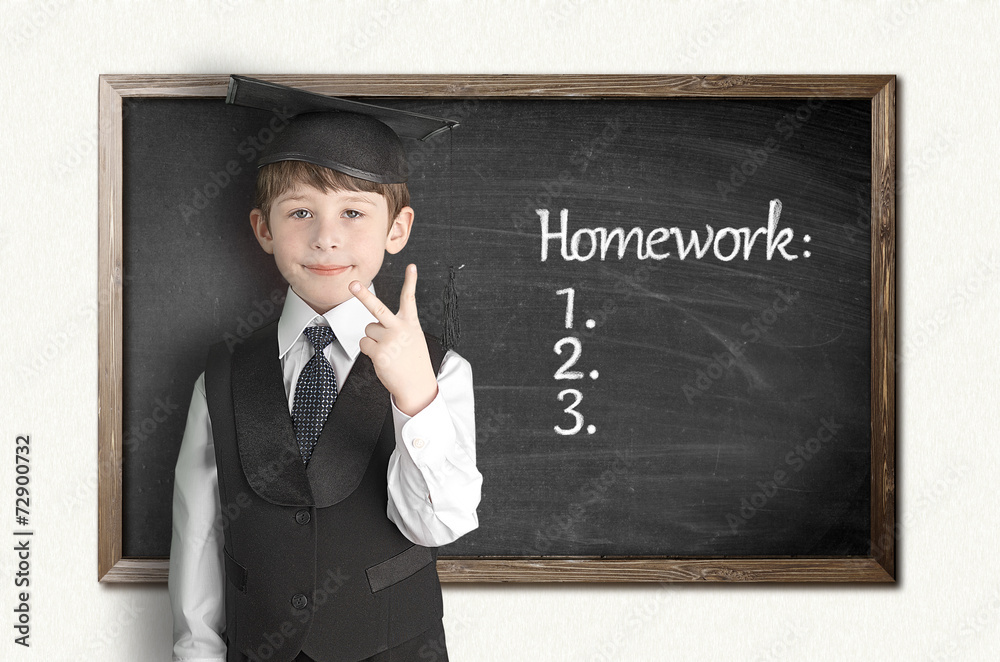 Cheerful little boy on blackboard. Looking at camera Cheerful little boy on blackboard. Looking at camera
