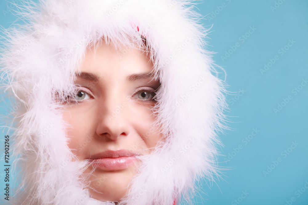 woman wearing santa claus costume covered her face on blue