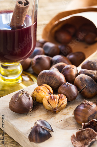 Delicious roasted chestnuts on wooden board