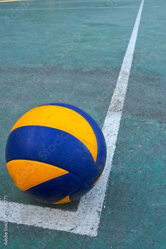 Old volleyball on a dirty court