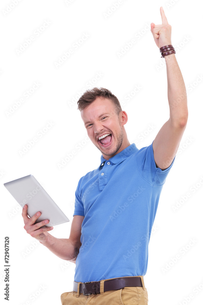 casual young man with tablet cheers