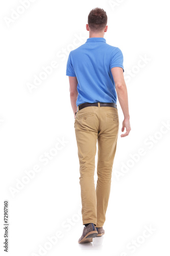 casual young man walks away from camera