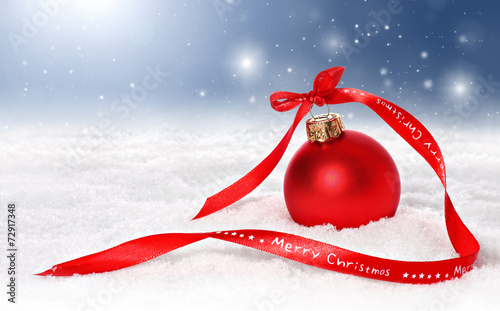 Holiday background with bauble, merry christmas ribbon in snow