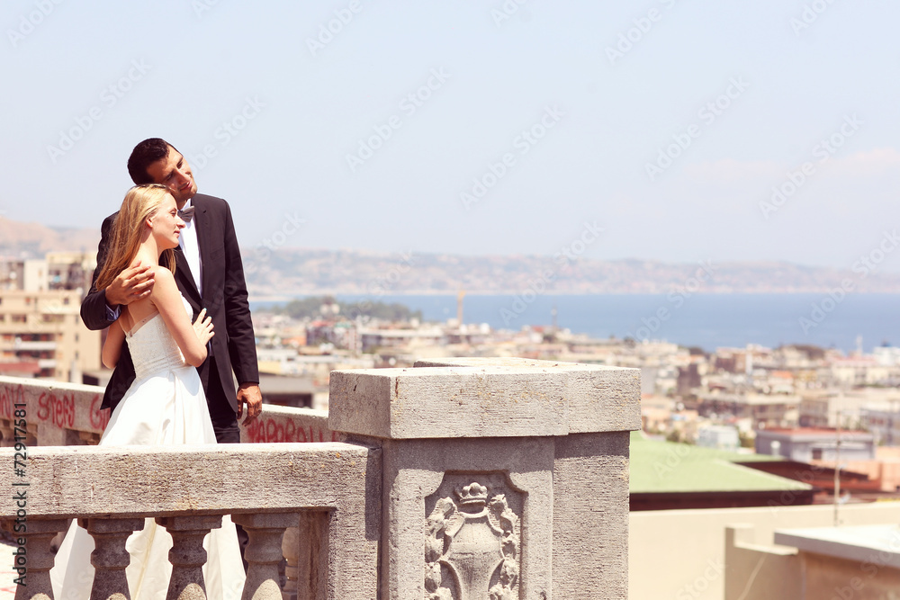 beautiful bride and groom on top of the city