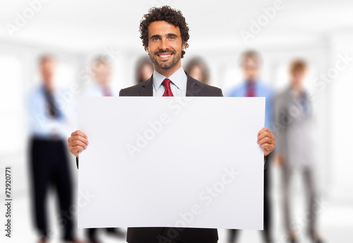 Man holding a white panel photo