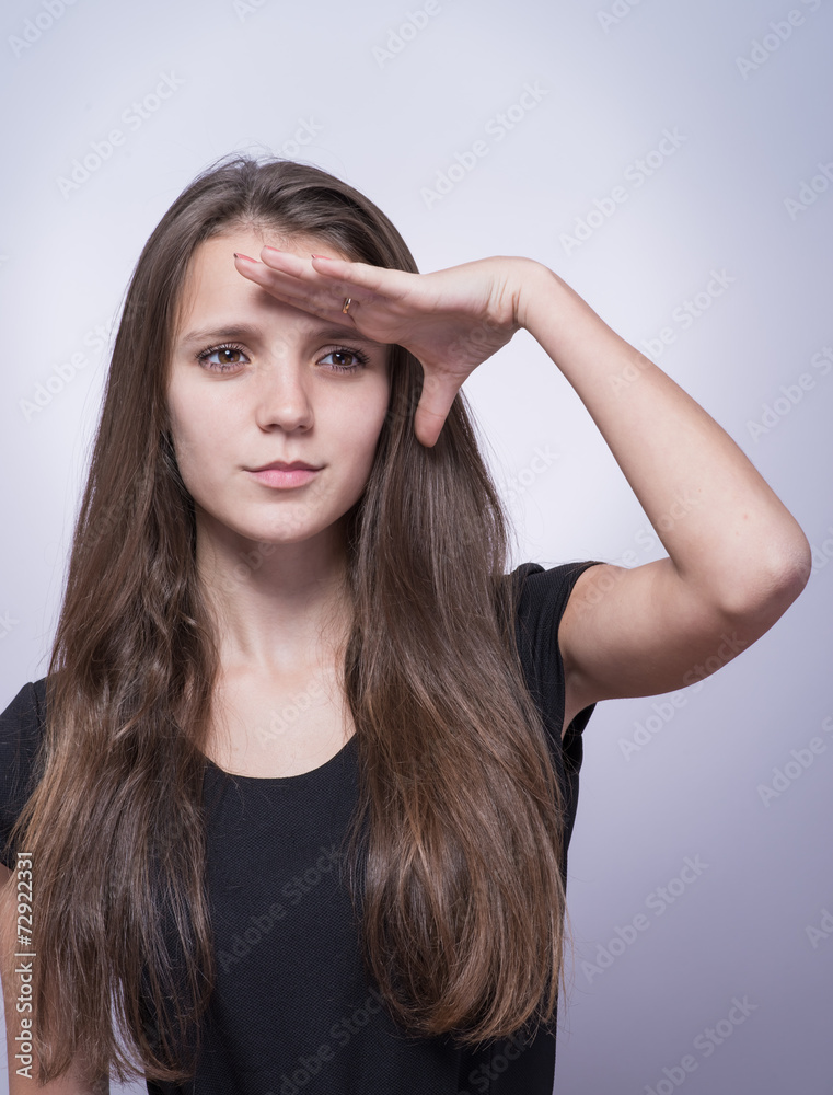 Woman with hand on forehead looking into distance