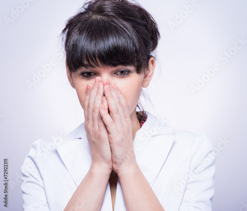 portrait of beautiful shy female stylish woman covering her face