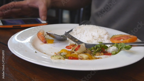 Wallpaper Mural Man eat food while playing mobile for social network Torontodigital.ca