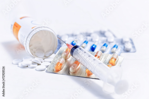 Syringe with glass vials and medications pills