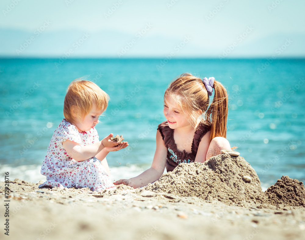 little girl builds a tower of sand little girl builds a tower of sand