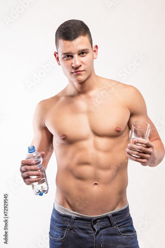 Muscular fitness man holding bottle and wather