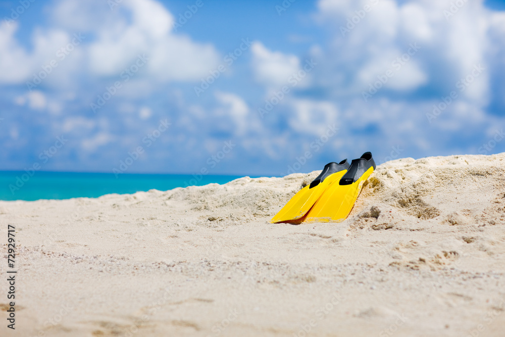 Yellow flippers on Maldivian beach in the Indian ocean Yellow flippers on Maldivian beach in the Indian ocean