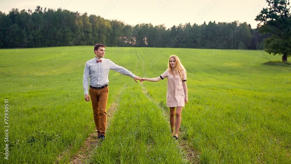 Loving Couple Holding Hands In Field