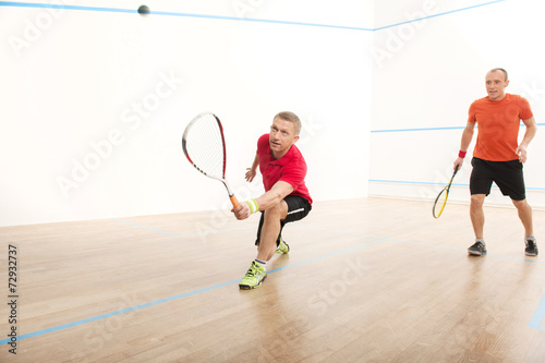 Two men playing match of squash.