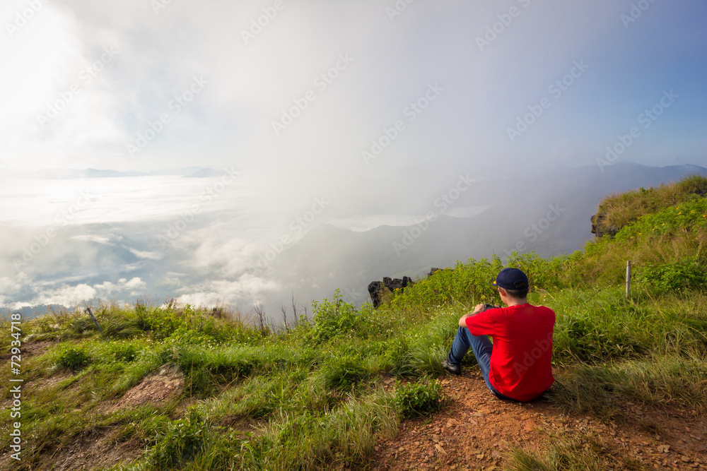A guy sitting at mountain view point