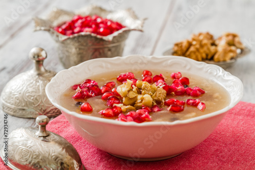 Turkish dessert Ashura, Noah's pudding, with pomegranate seeds and walnuts 