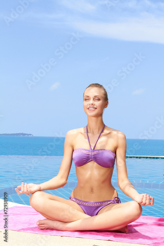 Serene young woman sitting meditating