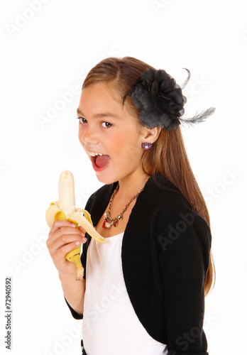 Girl eating banana.