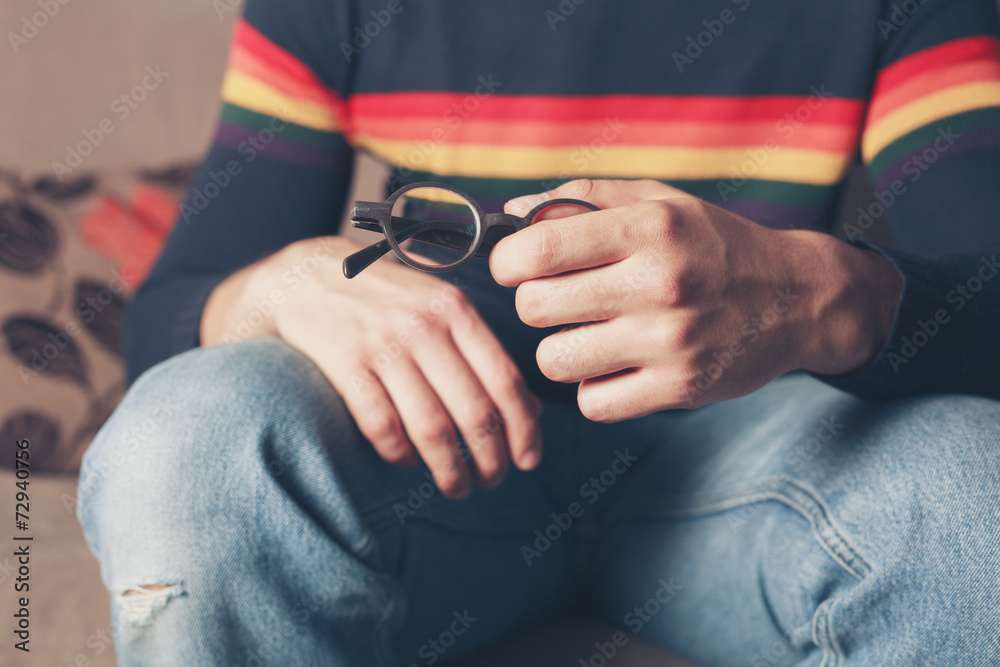 Fototapeta premium Young man with glasses in his hand