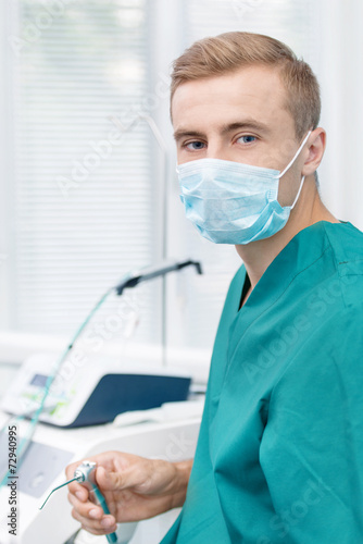 Young dentist in mask
