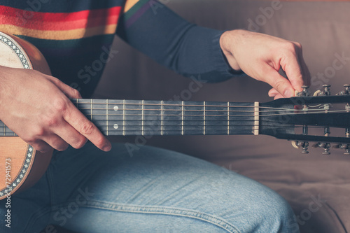 Man tuning guitar photo