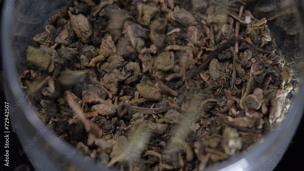 Pour black Indian tea in a glass jar. Large plan. Pour black Indian tea in a glass jar. Large plan.