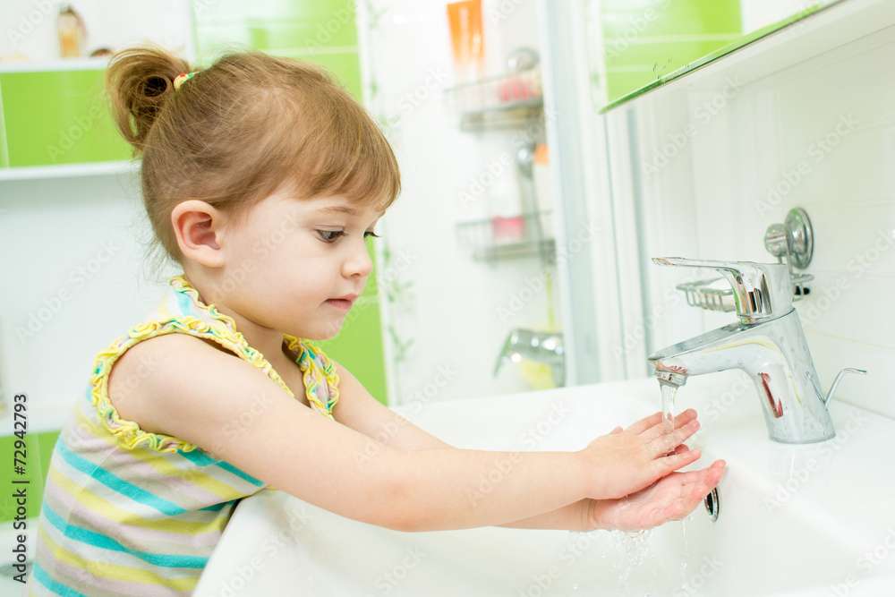 Cute little girl washing her hands in bathroom Stock Photo | Adobe Stock