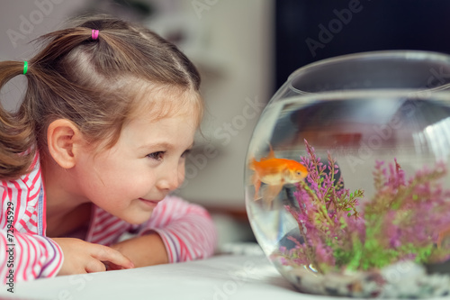 cute little girl and goldfish