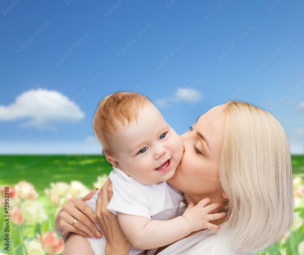 happy mother kissing smiling baby happy mother kissing smiling baby