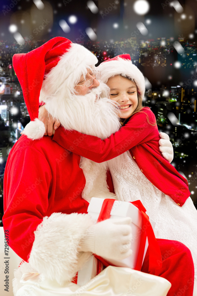 smiling little girl with santa claus and gifts smiling little girl with santa claus and gifts