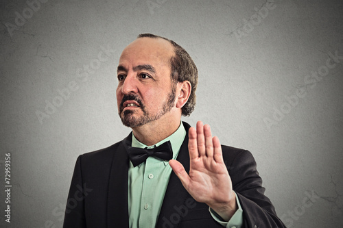 grumpy man with bad attitude giving talk to hand gesture