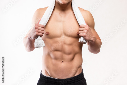 Fitness muscular man torso with towel