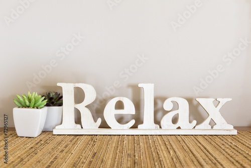 Relax written in large wooden letters with copy space