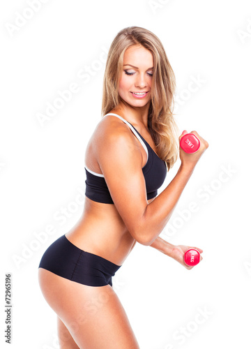 Beautiful slim woman with dumbbells, isolated on white