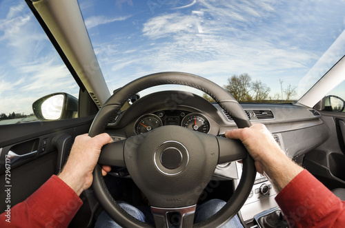 Fotografie, Tablou Driver's hands on steering wheel