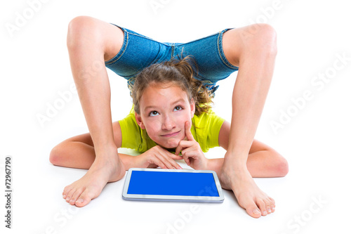 contortionist kid girl thinking gesture with tablet pc photo