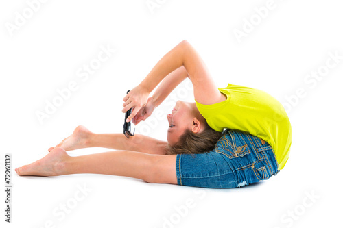 Flexible contortionist kid girl playing with tablet pc