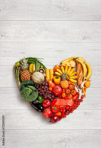 Fototapeta Naklejka Na Ścianę i Meble -  Heart symbol. Healthy eating concept / food photography of heart made from different fruits and vegetables on white wooden table