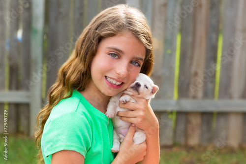 kid girl with puppy pet chihuahua playing happy