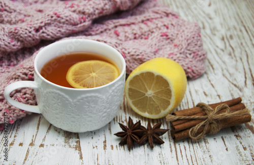 Cup of hot tea with lemon and scarf