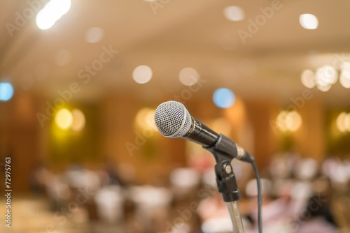 microphone in concert hall or conference room with lights in bac