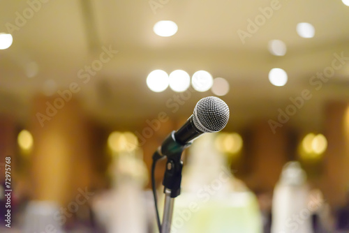 microphone in concert hall or conference room with lights in bac