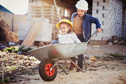 Canvas Print boy and girl playing on construction site