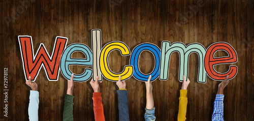 Group of Hands Holding Word Welcome photo