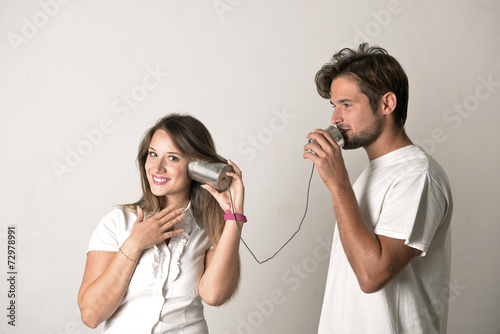 Couple talking through a tin phone