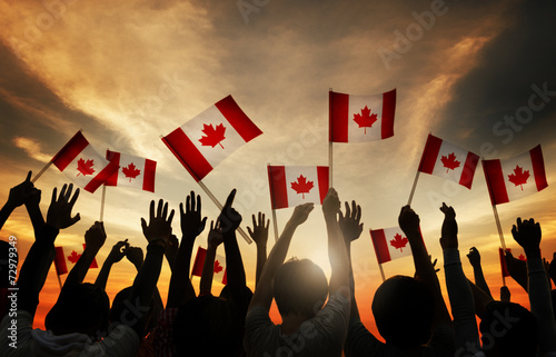 Group of People Waving Canada Flags photo