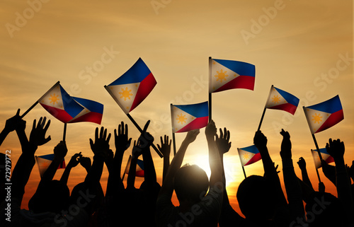 Group of People Waving Filipino Flags photo