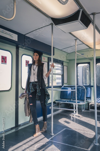 Pretty girl posing in a metro car