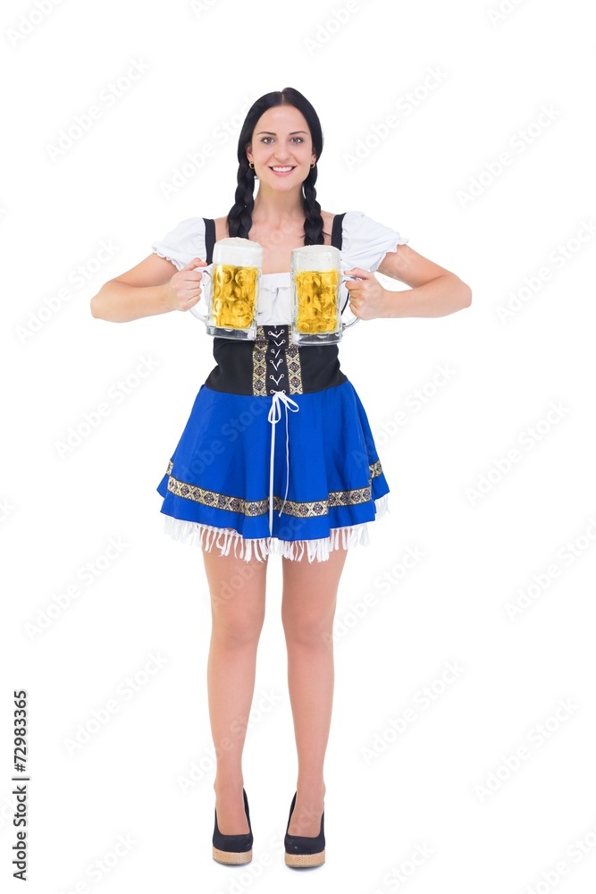 Pretty oktoberfest girl holding beer tankards Pretty oktoberfest girl holding beer tankards