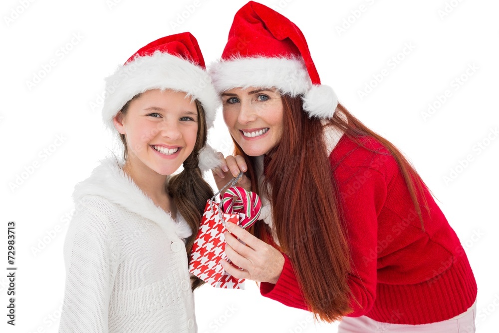 Festive mother giving daughter a gift Festive mother giving daughter a gift